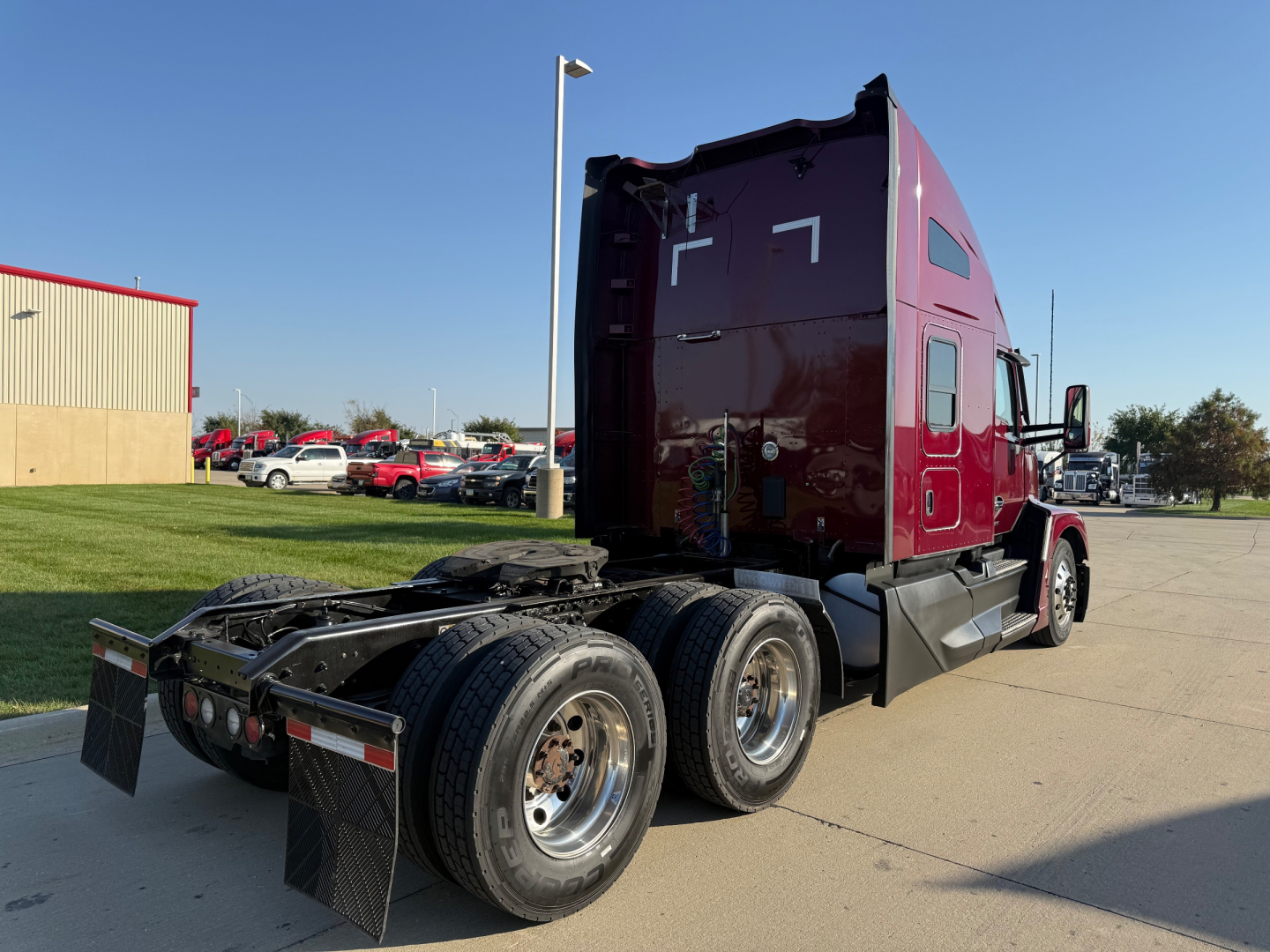Kenworth T680 sleeper cab tractor rear view showing dual rear axles and chassis