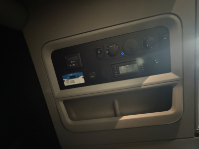 Dashboard panel view in a Kenworth T680 showing control dials and a digital display.