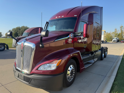 Kenworth T680 in-service conventional sleeper truck showing front grille, hood, and red cab with side mirrors.