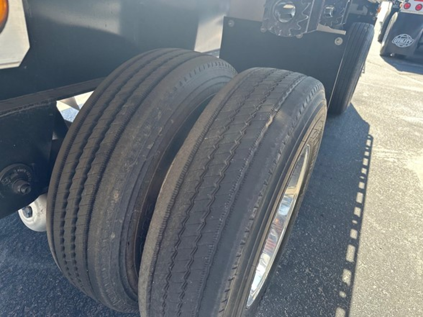 Air combo flatbed trailer dual tires visible on rear axle.