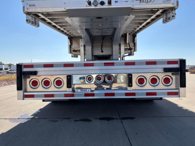Dropdeck trailer rear view showing multiple LED taillights and chassis frame undercarriage of a new 2027 Reitnouer dropdeck trailer.
