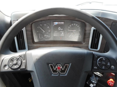 Dashboard view of a Western Star 49X cabin showing steering wheel with Western Star emblem, instrument cluster, and control buttons.