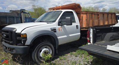 Ford F-450 XL Super Duty dump truck in white with orange dump bed, side view showing number 47 and utility truck bed attachments.