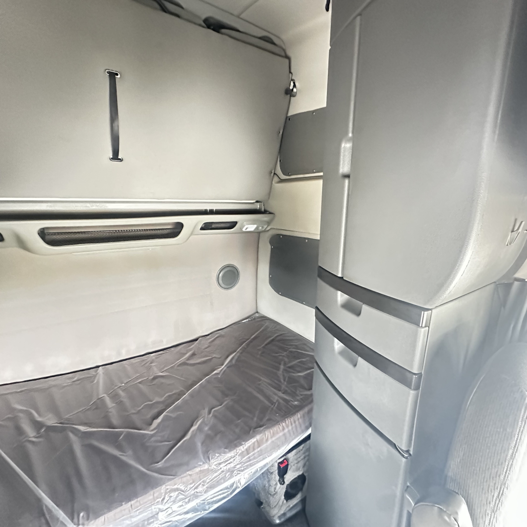 Volvo VNL860 sleeper cab interior showing bunk bed area and storage panels.