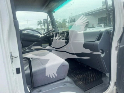 Isuzu NPR HD cab interior showing front seat and dashboard (driver side) with steering wheel and mat.