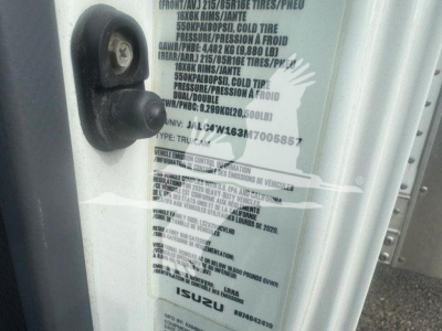 Isuzu NPR Hd cargo truck door sticker and VIN text label visible on the door jamb.