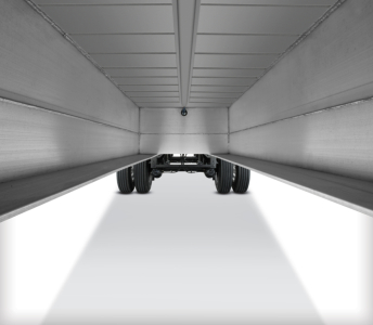 Underneath a Fontaine 48' aluminum flatbed trailer showing the underside beams and dual rear axles.