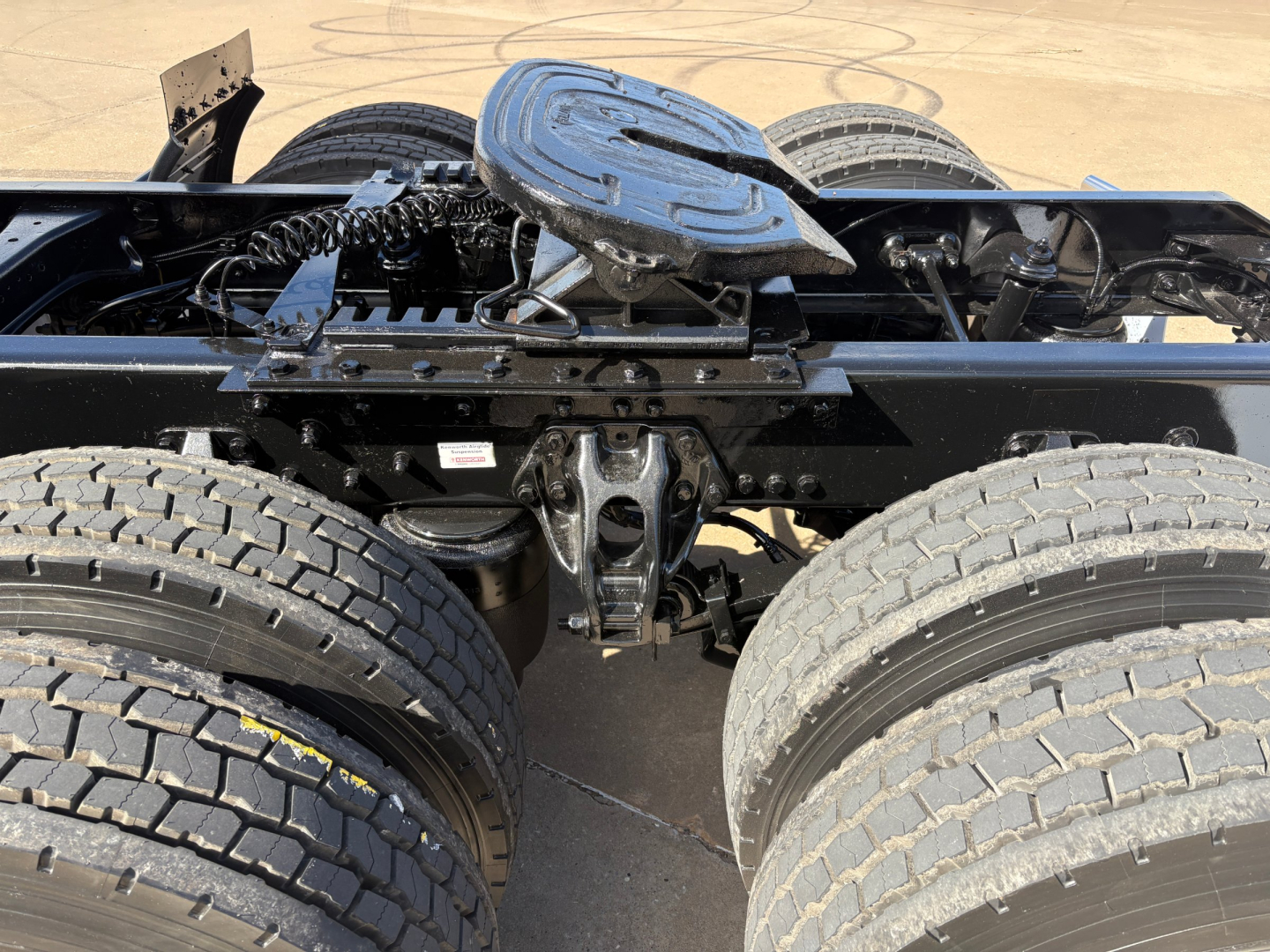 Kenworth T880 rear frame and dual rear axles view showing fifth wheel mounting and suspension components.
