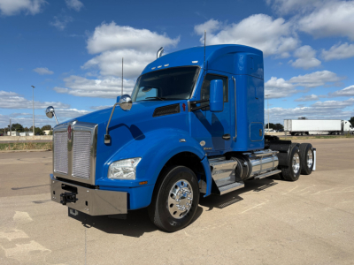 Kenworth T880 conventional sleeper truck in blue, front-three-quarter view with chrome accents and dual rear axles.