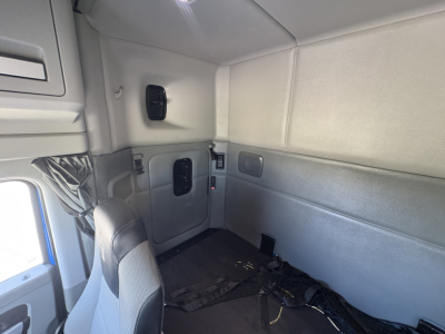 Kenworth T880 sleeper cab interior showing side panels and seating area with seat belt secured.