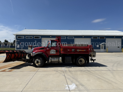 Dump truck side view showing International 7400 with snowplow attachment and red dump bed.