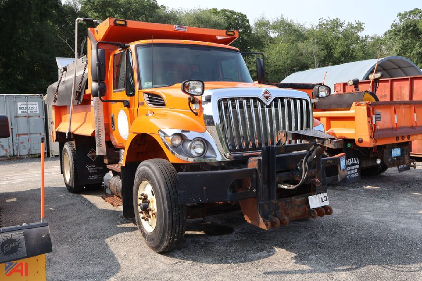 Orange 2014 International WorkStar 7400 dump truck viewed head-on with front bumper attachments and dump bed visible
