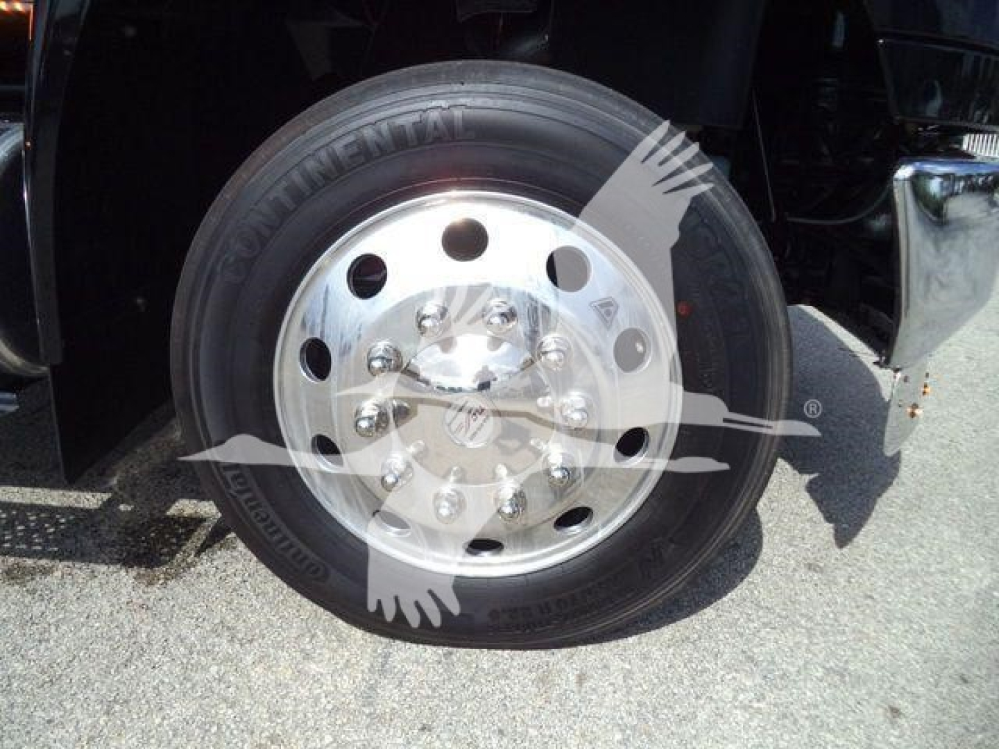 Truck wheel and tire showing Continental tire on polished steel rim