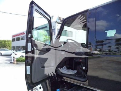 Truck cab area with front passenger door open, interior and dashboard visible, black exterior, MV607EXCAB22ITD text not visible.