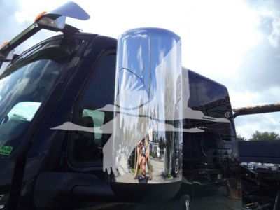 Truck cab mirror and door area of a new 2027 International MV rollback truck showing chrome side mirror and black body.