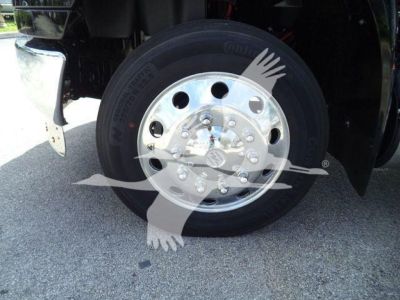 Wheel/tire and polished steel hub on a truck front axle showing tire brand and lug nuts.