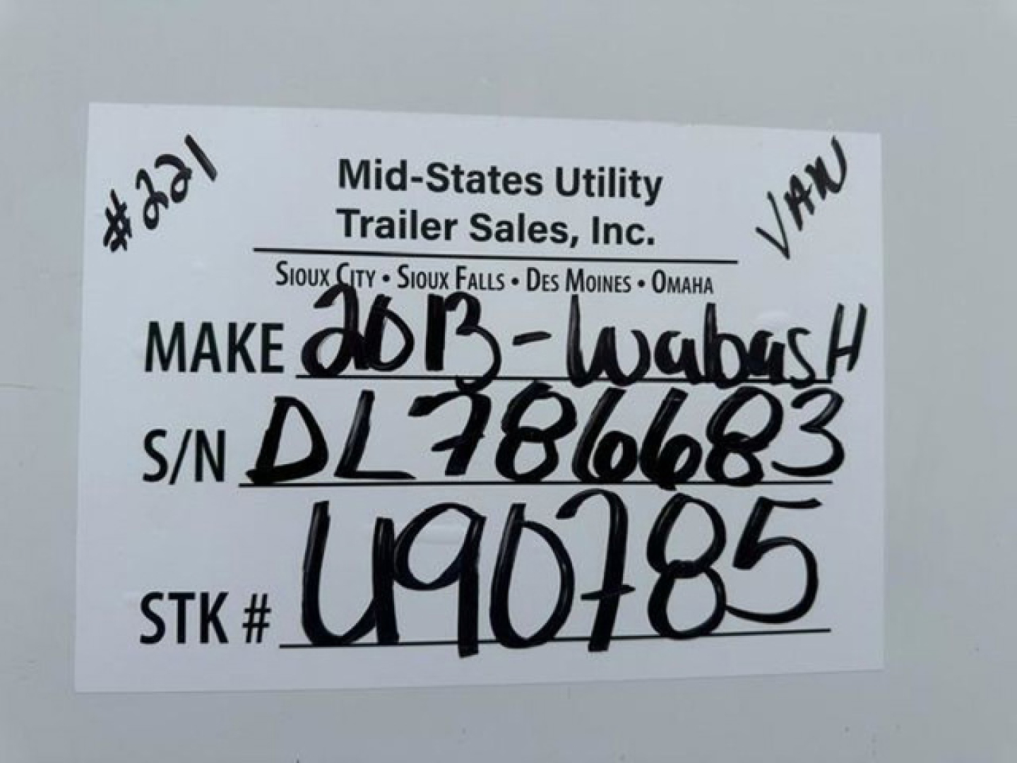 Label on trailer showing Mid-States Utility Trailer Sales, Inc. handwritten VIN and stock numbers: S/N DL2816683, STK # U90785, Make 2013-Wabash, VAN trailer.