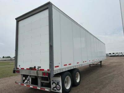 Trailer side and rear of a 2013 Wabash van trailer showing dual rear axles and reflective striping.