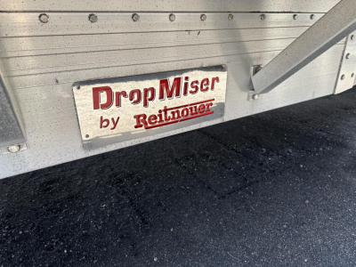 DropMiser by Reitnouer plate mounted on aluminum trailer side with riveted panels and a drop deck frame.
