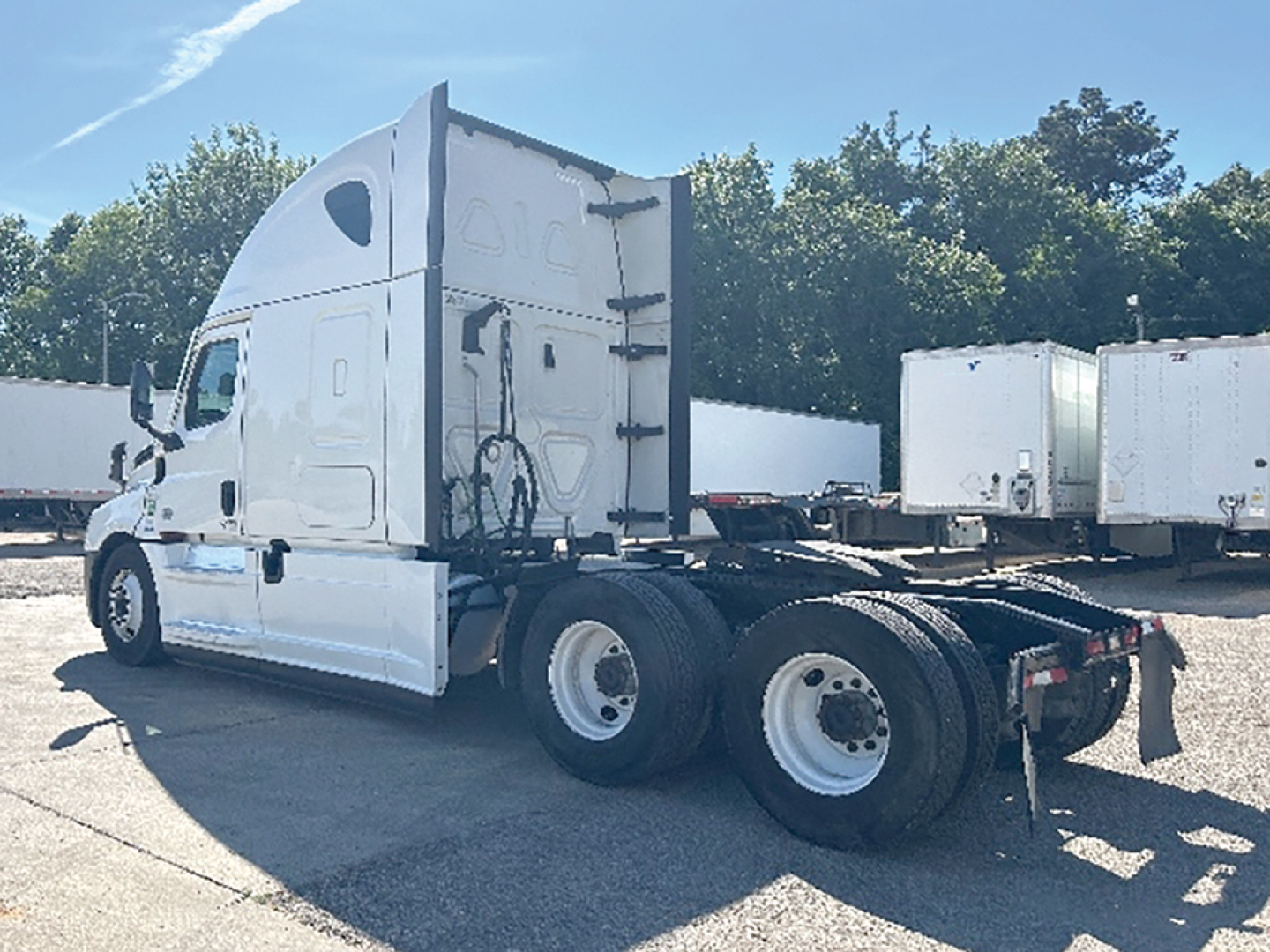 Freightliner Cascadia126 sleeper tractor in-park showing rear wheel duals and chassis with fifth wheel missing cab area and fuel tanks visible