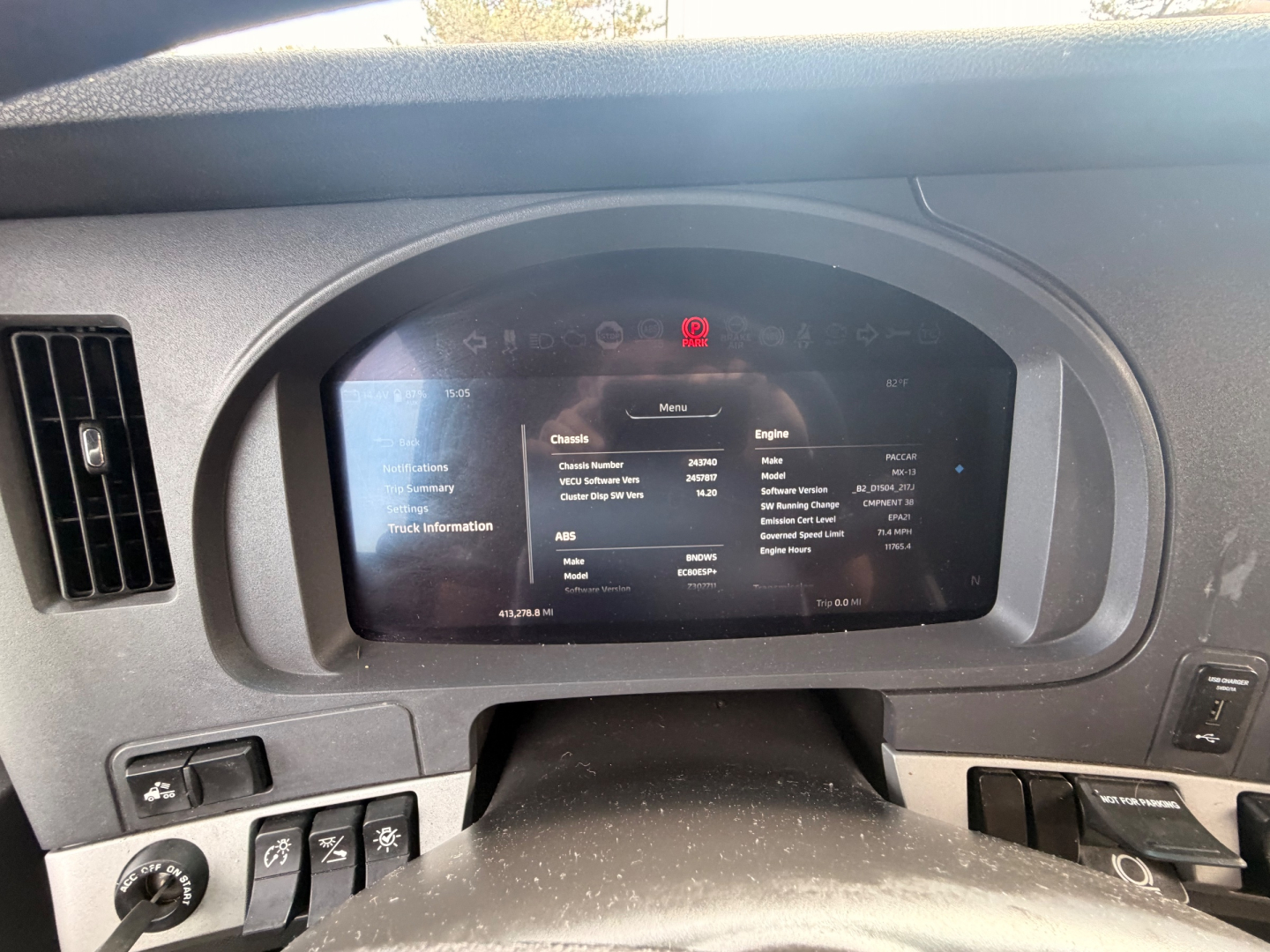 Kenworth T680 dashboard display showing vehicle information screen with chassis and engine details.