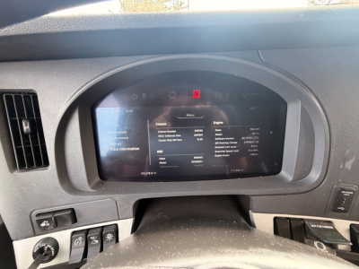 Kenworth T680 dashboard display showing vehicle information screen with chassis and engine details.