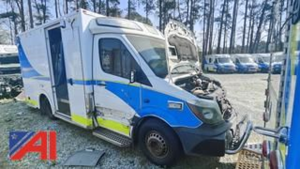 Ambulance cab and body of a 2016 Mercedes-Benz Sprinter ambulance viewed from the side, with open hood and blue/yellow graphics.