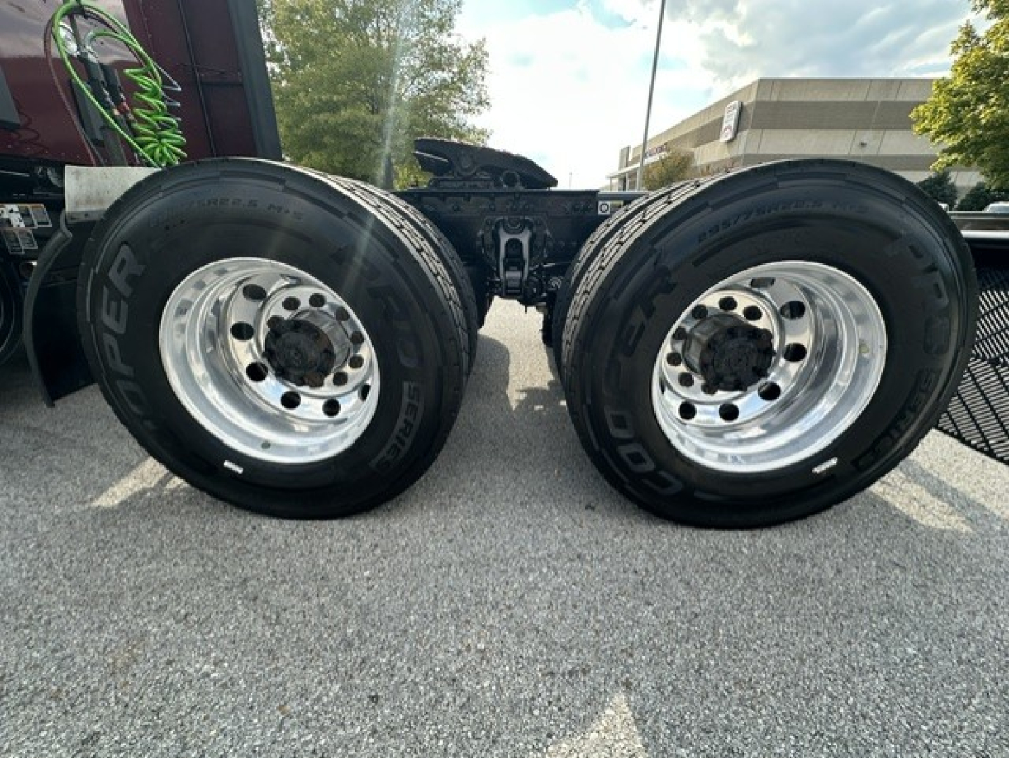 Kenworth T680 rear dual tires on axle showing wheel rims and tire branding.
