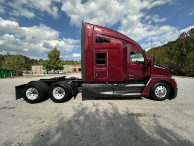 Kenworth T680 side profile showing tractor cab and dual rear axles in maroon color.