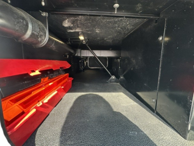 Kenworth T680 truck interior storage area showing red tool drawers and side compartments.
