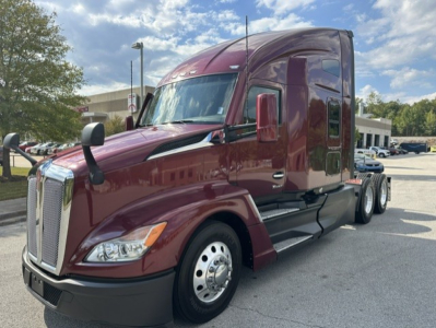 Kenworth T680 tractor shown in burgundy with sleeper cab, front grille, and dual rear axles. No visible text other than vehicle features.