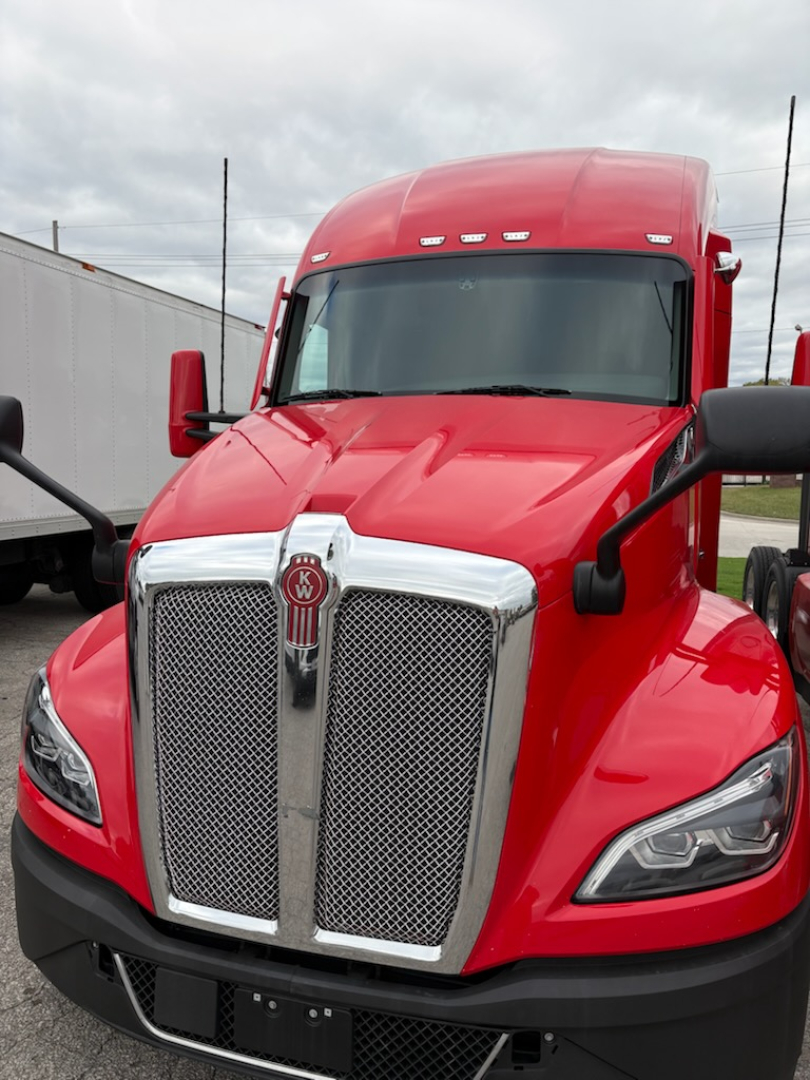 Kenworth T680 truck in red color front view showing grille and headlights.