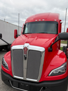 Kenworth T680 truck in red color front view showing grille and headlights.