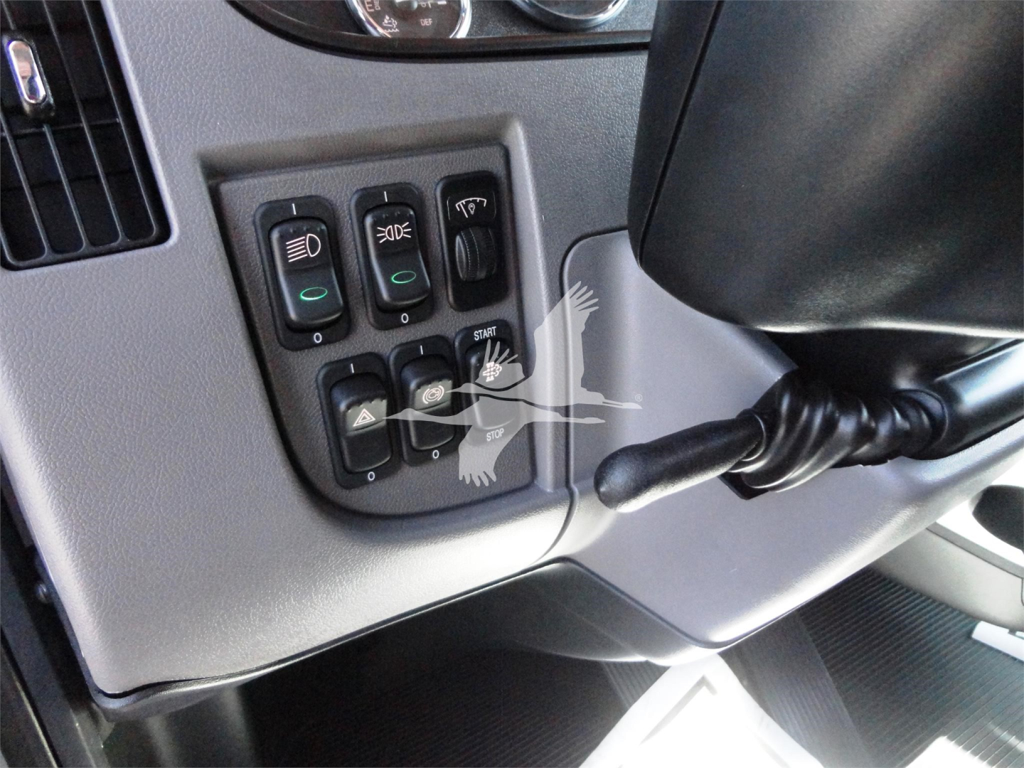 Peterbilt 337 dashboard controls panel with multiple switches and stalk, close view of operation levers and climate controls.