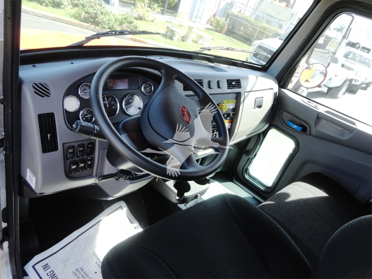 Peterbilt 337 truck interior showing steering wheel and dashboard with gauges and controls.