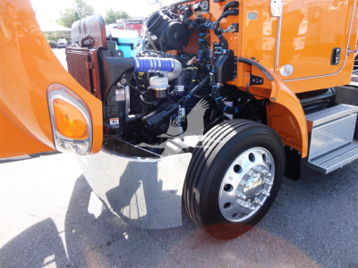 Peterbilt 337 rollback truck engine bay with orange cab open showing large front wheel and engine components