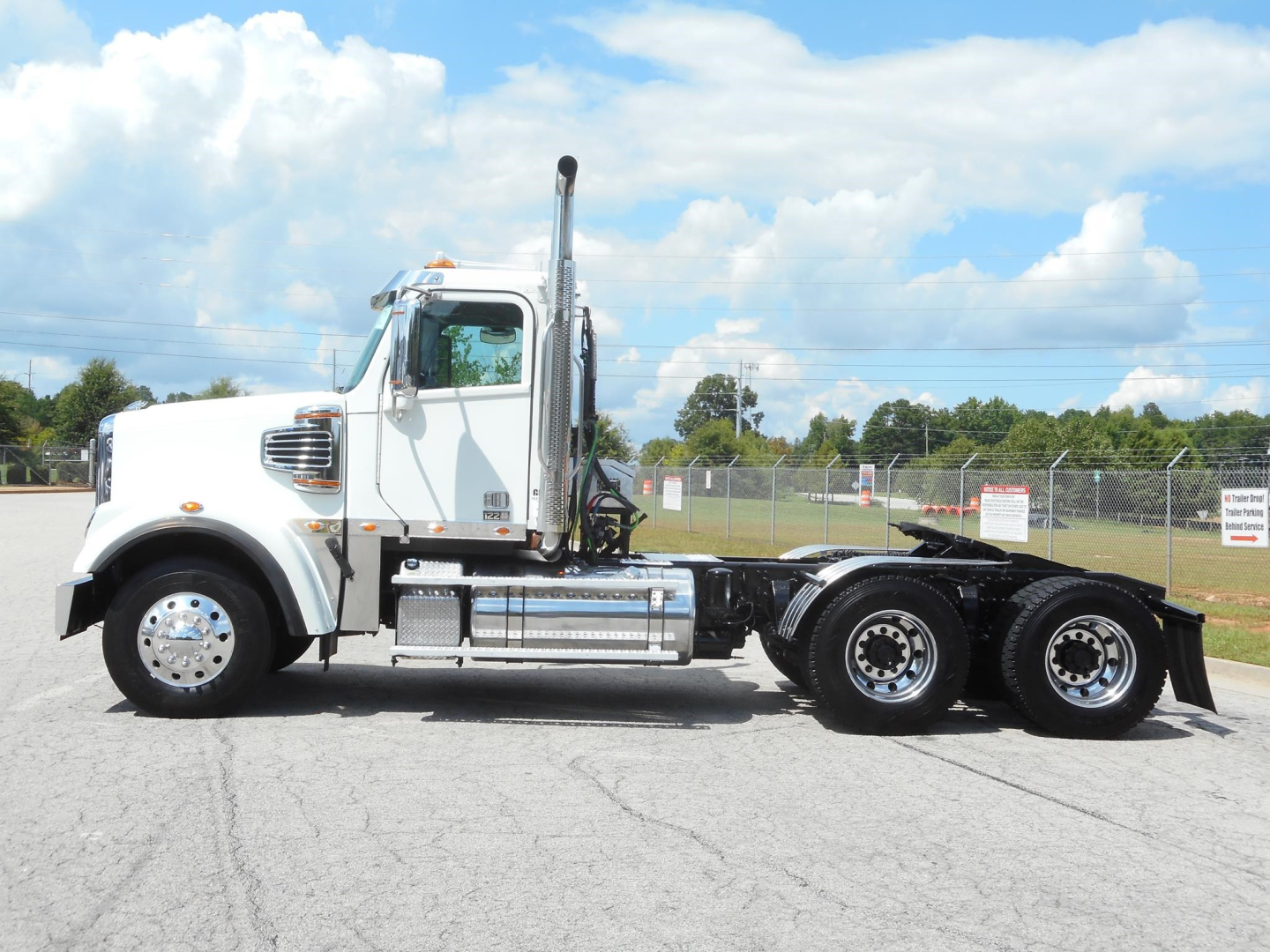 2019 Freightliner 122SD truck side view showing chassis and cab with chrome exhaust stack.