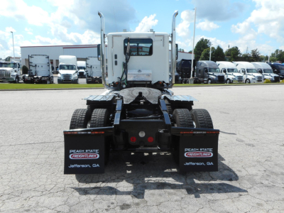 Rear of a Freightliner 122Sd day cab truck showing mud flaps with Peach State Freightliner Jefferson, GA text and two red reflectors on the chassis.