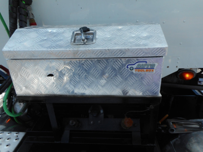 Aluminum diamond-plate tool box on Freightliner 122SD with Auto Tool Box logo visible.