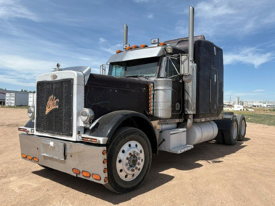 Peterbilt 379 UltraCab conventional sleeper truck with extended hood, front chrome grille, dual air cleaners, and large fuel tanks.