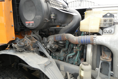 Volvo VNM engine bay showing radiator hoses and intake components.