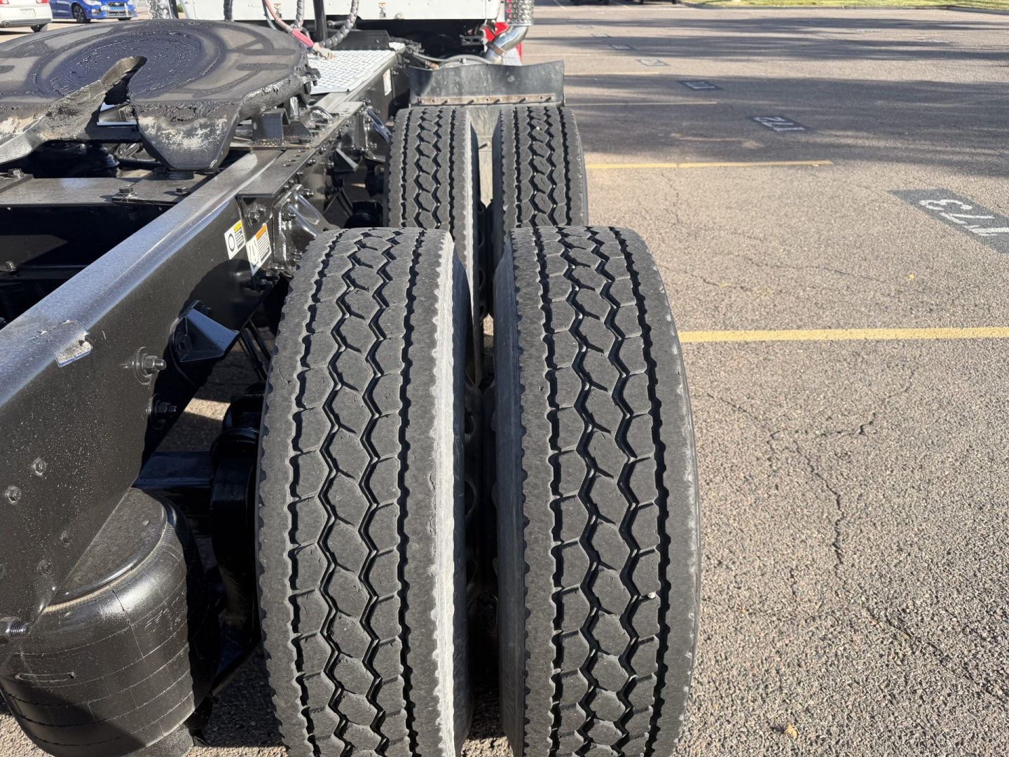 Kenworth T880 chassis and dual rear wheels showing treaded tires and frame with connectors.