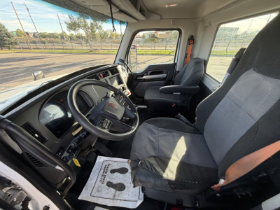 Kenworth T880 truck cab interior showing steering wheel, dashboard, and front seats with gray and black upholstery.