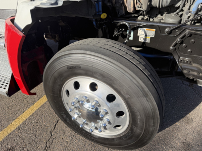 Kenworth T880 front wheel and engine bay partial showing wheel hubs and tire