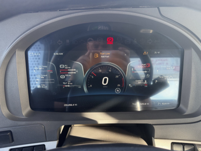 Kenworth T880 instrument cluster display showing digital gauge at 0 mph, warning icons, and fuel/temp readouts.