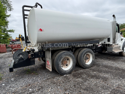 Peterbilt 548 water truck with a 4000 gallon tank, side view showing dual rear axles and tanker with white tank.