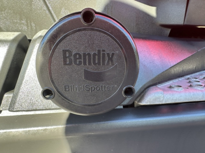Kenworth truck component showing Bendix BlindSpotter sensor cap with embossed Bendix logo on round cover.