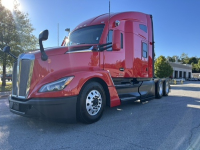 Kenworth T680 conventional sleeper truck in red, front three-quarter view, showing cab, front grille, headlights, and dual rear axles.