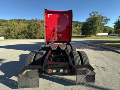Kenworth T680 rear view showing fifth wheel and dual fuel tanks under red cab, no trailer attached.