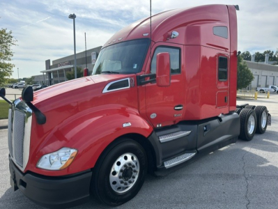 Kenworth T680 truck in red, front-left view, with cab and sleeper. Visible text includes Kenworth emblem on grille and no other legible labels in image.